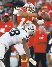  ?? ED ZURGA — ASSOCIATED PRESS ?? Raiders cornerback TJ Carrie makes an acrobatic move but can’t stop Chiefs receiver Albert Wilson’s catch.