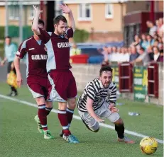  ??  ?? Former player Anton Brady goes down under the challenge of Stenny and ex-Queen’s Park man Vinnie Berry