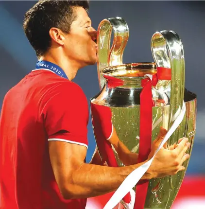  ??  ?? Bayern’s Robert Lewandowsk­i kisses the trophy. Photo: AP