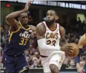  ?? TONY DEJAK — THE ASSOCIATED PRESS ?? LeBron James drives against the Jazz’s Ekpe Udoh during the second half of the Cavaliers’ victory on Dec. 16.