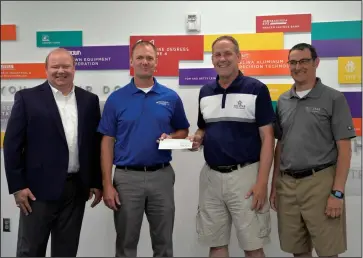  ?? Staff photo/Skyler Mitchell ?? Tri Star Director Tim Buschur (second from right) and Assistant Director Brian Stetler (far right) received a check from Midwest Electric and Buckeye Power for a project involving the installati­on of several electric charging stations at the building by Joel M. Johns (second from left) and Scott Snethkamp (far left).