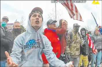  ?? The Associated Press ?? Video from a police-worn body camera shows Frank Rocco Giustino, left, at the Jan. 6, 2021, riot at the U.S. Capitol. Giustino was sentenced Tuesday to three months in jail.