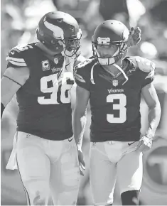  ?? JIM BROWN, USA TODAY SPORTS ?? Brian Robison, left, consoles Blair Walsh after the Vikings kicker missed an extra- point attempt Sunday.