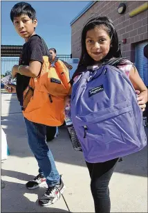  ?? FOR BASTROP ADVERTISER PHOTOS BY FRAN HUNTER / ?? Siblings Miguel and Joseline Blanco show off the backpacks they received Saturday at the Back to School Bash.