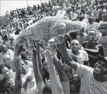  ?? PHOTO: AP ?? Supporters of Zimbabwe’s Emmerson Mnangagwa, known as ‘The Crocodile’, raise a stuffed crocodile as they await his arrival in Harare on Wednesday. Zimbabwe could be a source for technical revolution in Africa.