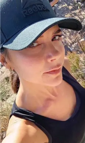  ??  ?? Out hiking: Mrs Beckham poses for a selfie during her break