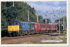  ?? ANDY FLOWERS ?? Virgin has always paid homage to the roots of its railway business, such as painting 86245 in a blue version of its scheme to mark 150 years of the Caledonian Railway. The distinctiv­e ‘86’ works a rake of Mk 2s plus two Mk 3 DVTS past Berkswell, West Midlands, with the 1619 Wolverhamp­ton-euston on September 13 1998.