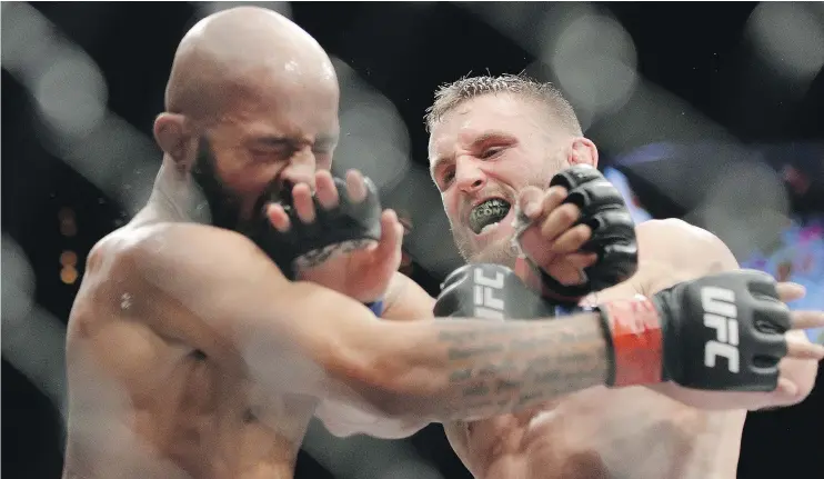  ?? — AP FILES ?? Tim Elliott, right, gave Demetrious Johnson fits when they fought a year ago. Elliot meets unbeaten newcomer Pietro Menga in UFC action on Saturday in Winnipeg.