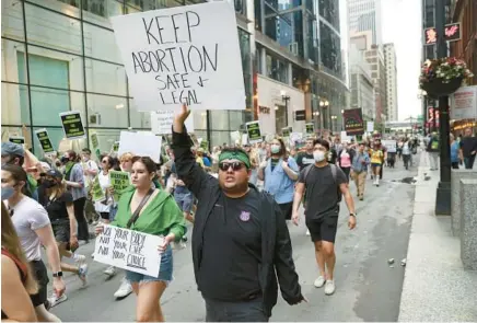  ?? CHRIS SWEDA/CHICAGO TRIBUNE ?? People march in protest through downtown Chicago on June 25 after the Supreme Court overturned Roe v. Wade.