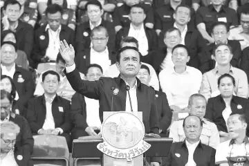  ?? — AFP photo ?? Prayut delivers his address at a massive gathering in Buriram FC’s Thunder Castle stadium in Buriram.