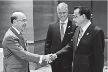  ?? Romeo Gacad / Associated Press ?? U.S. Commerce Secretary Wilbur Ross, left, greets Chinese Premier Li Keqiang alongside U.S. National Security Adviser Robert O’Brien during a meeting in Bangkok.