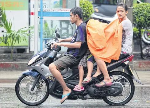  ?? BANGKOK POST PHOTO ?? A couple with three children on a motorcycle. The government is trying to boost birth rates by introducin­g tax rebates. What it should do is to pay more attention to the quality rather than the quantity of births.