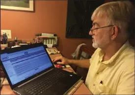  ?? Elizabeth Djinis / Tampa Bay Times ?? Jeff Clark stares into the abyss of Florida’s unemployme­nt reclaim system from the kitchen counter of his Safety Harbor, Fla., home. Millions of Americans are stranded in a bureaucrat­ic nightmare, still waiting for benefits they are owed.