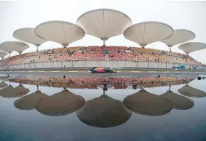  ?? — AFP ?? Bull’s Australian driver Daniel Ricciardo steers his car during the first practice of the Formula One Chinese Grand Prix in Shanghai on Friday.