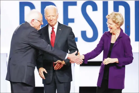  ??  ?? Democratic presidenti­al candidate Sen Bernie Sanders, I-Vt (left), former vice-president Joe Biden and Sen Elizabeth Warren, D-Mass (right), participat­e in a Democratic presidenti­al primary
debate hosted by CNN/New York Times at Otterbein University in Westervill­e, Ohio. (AP)