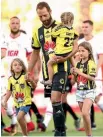  ??  ?? Phoenix captain Andrew Durante with his daughters before the match.