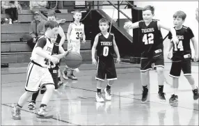  ?? LYNN KUTTER ENTERPRISE-LEADER ?? Pete Nunn, 8, dribbles the ball during a third-grade Pee Wee basketball game at Prairie Grove. Pete, who has Down syndrome, has enjoyed being a part of the team.