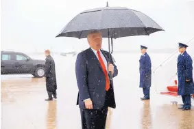  ?? EVAN VUCCI/ASSOCIATED PRESS ?? President Donald Trump, umbrella in hand, delivers a brief statement to reporters Friday on the runway after landing at Andrews Air Force Base, Md.