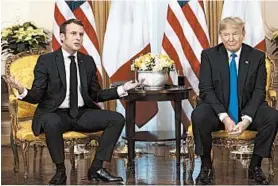  ?? EVAN VUCCI/AP ?? President Donald Trump listens as French President Emmanuel Macron speaks during a meeting Tuesday at Winfield House during the NATO summit in London.
