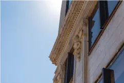  ?? Staff photo by Kelsi Brinkmeyer ?? ■ Restoratio­n of the former Texarkana National Bank building’s granite, terra cotta and brick exterior is under way. The various materials are being restored using different techniques narrowed down by trial and error.