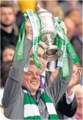  ??  ?? Neil Lennon with the Scottish Cup, which clinched Celtic’s treble Treble