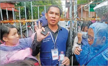  ?? HENG CHIVOAN ?? Licadho’s monitoring manager Am Sam Ath talks to reporters after he was hit in the mouth and face at a World Habitat Day march on October 10.