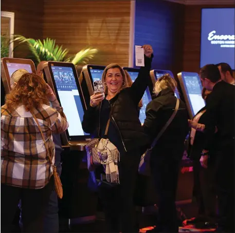  ?? NANCY LANE — BOSTON HERALD ?? A woman shows off her receipt as the first sports bets are placed at the Encore Boston Harbor casino last month. A few stumbles are being reported.