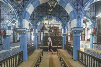  ?? AP file photo ?? A tourist visits La Ghriba, the oldest synagogue in Africa, on the Island of Djerba, southern Tunisia, Oct. 28, 2015. The Tunisian Interior Ministry says a naval guard shot and killed a colleague and two civilians on Tuesday, near the synagogue during an annual Jewish pilgrimage.