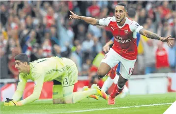  ??  ?? Theo Walcott wheels away in delight after scoring Arsenal’s second.