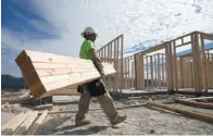  ?? GREGORY BULL / THE ASSOCIATED PRESS ?? Miguel Fonseca carries lumber to a new home in Chula Vista, Calif. Improvemen­t in the U.S. housing market may
mean an end to the 30-year downturn in bond yields.