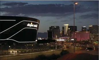  ?? AP PHOTO/JOHN LOCHER ?? Lights adorn Allegiant Stadium, new home of the Las Vegas Raiders football team, as it nears completion Wednesday, July 22, in Las Vegas. The stadium will also serve as the home for the UNLV football team.