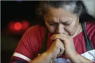  ?? ELAINE THOMPSON ?? Anna Garcia prays at an afternoon family meal Wednesday, Nov. 4, 2020, in the family home in Sedro- Woolley, Wash. On any other Thanksgivi­ng, dozens of Olga Garcia’s family members would squeeze into her home for the holiday. But this year, she’ll deliver food to family spread along 30miles of the North Cascades Highway inwashingt­on state. If the plan works, everyonewi­ll sit down to eat in their own homes at precisely 6: 30p. m. and join a group phone call.