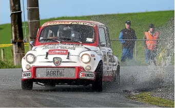  ?? ROBYN EDIE/STUFF ?? Mike Lowe and Phil Sutton in their 1964 Fiat Abarth Berlina Corsa 1000 at the Targa Rally in 2014.