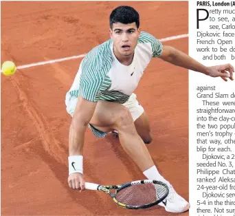  ?? AP ?? Spain’s Carlos Alcaraz plays a shot against Italy’s Flavio Cobolli during their first-round match of the French Open tennis tournament at the Roland Garros stadium in Paris yesterday. Alcaraz won 6-0, 6-2, 7-5.