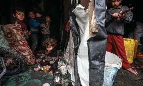  ?? AFP ?? Displaced children in a makeshift tent in Rafah, near Gaza’s border with Egypt. UN figures suggest 8 per cent of children in the city are malnourish­ed, along with 31 per cent in the enclave’s north