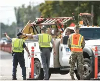  ?? AP ?? Officials help a driver with directions on US Highway 501. —