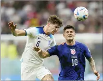  ?? LUCA BRUNO — THE ASSOCIATED PRESS ?? England’s John Stones vies for the ball with Christian Pulisic of the United States, right, during the World Cup group B soccer match between England and The United States, at the Al Bayt Stadium in Al Khor , Qatar on Friday.