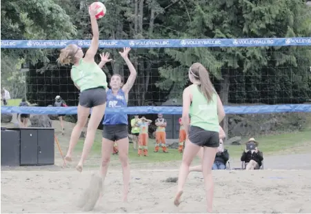  ?? KELLIE PURDY ?? Erin Mutch leaps to spike the ball while Island teammate Savannah Purdy looks on en route to the gold medal in girls’ beach volleyball at the 2018 B.C. Summer Games this month in the Cowichan Valley.