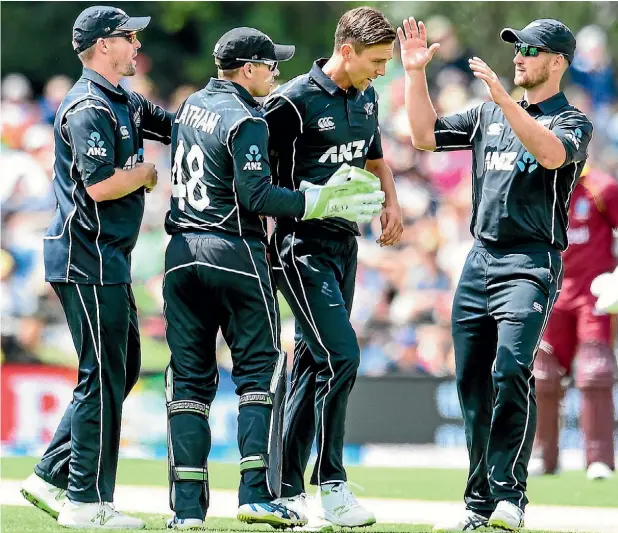  ??  ?? Colin Munro, Tom Latham, Trent Bould and Neil Broom celebrate as another West Indies wicket falls.