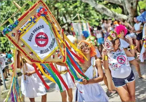  ?? AFP ?? Revelers in Rio de Janiero wearing Greek style costumes call for Zika virus prevention in 2016.