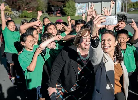  ?? IAIN MCGREGOR / STUFF ?? Jacinda Ardern poses for photos with schoolchil­dren in Canterbury – such selfies and social media ‘‘likes’’ are replacing traditiona­l polling to reveal, for example, who’s ahead in the National leadership popularity stakes: Judith Collins or Simon Bridges.