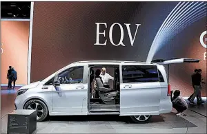  ?? Bloomberg News/ALEX KRAUS ?? Attendees inspect a Mercedes-Benz EQV electric van in the Daimler AG exhibition hall last week at the IAA Frankfurt Motor Show in Frankfurt, Germany.