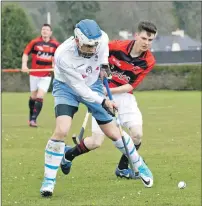  ?? Photograph: Donald Cameron. ?? Skye’s Iain MacLellan holds off Glenurquha­rt’s Jamie MacLennan during their North Division One match. Taynuilt’s Willie Lafferty scored four goals in his team’s 5-2 win over Ballachuli­sh.