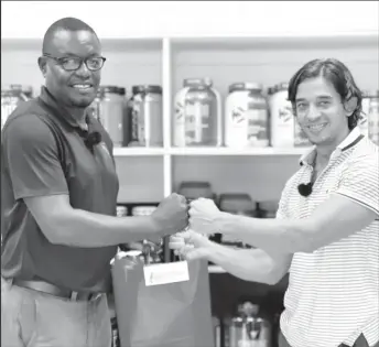  ?? ?? GFF Assistant Technical Director Bryan Joseph (left) receives the hampers from Fitness Express Manager and owner Jamie McDonald.