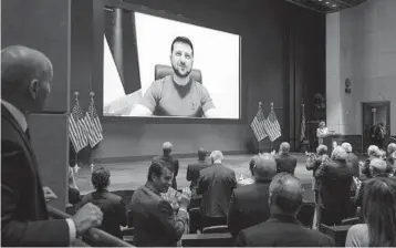  ?? ?? President Zelenskyy gets an ovation as he delivers a virtual address to Congress.