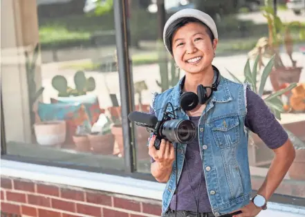  ?? JOSHUA A. BICKEL/COLUMBUS DISPATCH ?? Videograph­er Anita Kwan, owner of Reel Hoot Production­s, outside client Heartfelt Cycle Studio near Grandview Heights. Kwan is passionate about using her video production company to highlight Lgbtq-owned, Poc-owned and women-owned businesses.