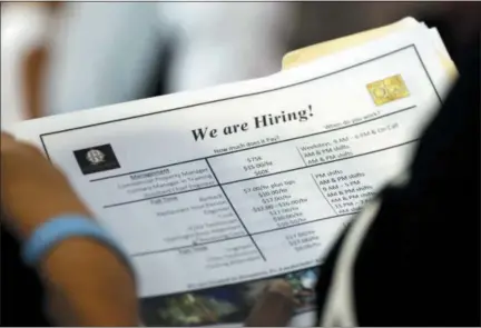  ?? THE ASSOCIATED PRESS ?? A job applicant looks at job listings for the Riverside Hotel at a job fair hosted by Job News South Florida, in Sunrise, Fla. The U.S. unemployme­nt rate fell to 3.7 percent in September 2018, the lowest level since December 1969 — signaling how the longest streak of hiring on record has put millions of Americans back to work.