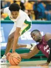  ?? ?? Norfolk State’s Jaylani Darden, left, battles Alabama A&M’s Lorenzo Downey for a loose ball during a CIT semifinal Saturday at Echols Hall.