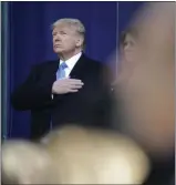  ?? SETH WENIG — THE ASSOCIATED PRESS ?? President Donald Trump puts his hand over his heart during a wreath-laying ceremony Monday at the opening ceremony of the New York City Veterans Day Parade in New York.