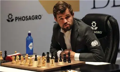  ?? Photograph: Giuseppe Cacace/AFP/Getty Images ?? Magnus Carlsen confessed to enormous relief as he was able to take advantage of a lapse by Ian Nepomniach­tchi to scramble a draw.